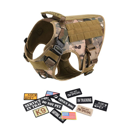 Camo tactical dog harness with handle, buckles, and assorted Velcro patches.
